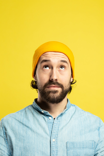 Portrait of Worried and Thinking Man, Yellow Background