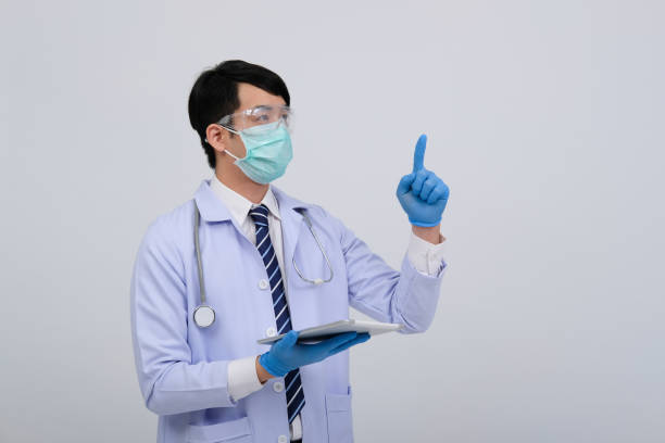 istock doctor physician practitioner wearing mask with tablet & stethoscope on white background. medical healthcare concept 1213188107
