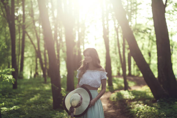 Beauty young girl in hat outdoors enjoying nature