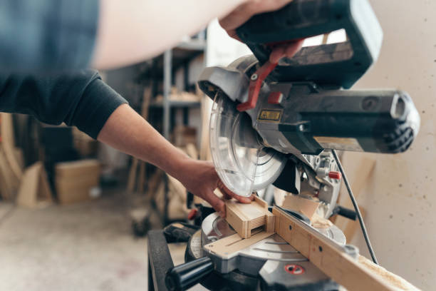 istock Male carpenter working on the wood cutter machine 1213190280