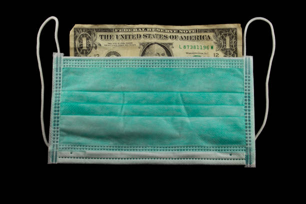 istock Wrinkled Dollar Bill behind a medical face mask 1213191916