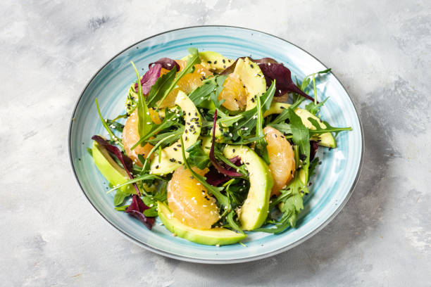 istock Vegan grapefruit, avocado and arugula salad on a concrete background. 1213192385