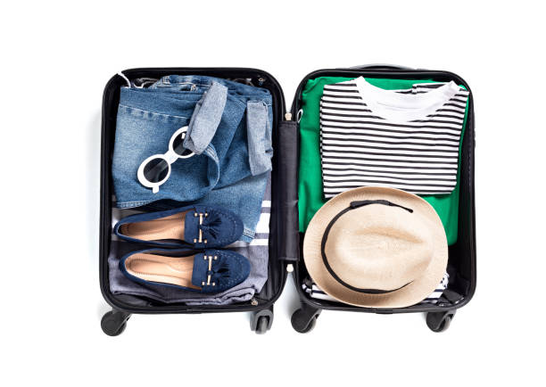 istock Flat lay with open suitcase with casual clothes for summer vacations over white background. Summer holidays, travel, tourism, flight luggage concept. 1213194602