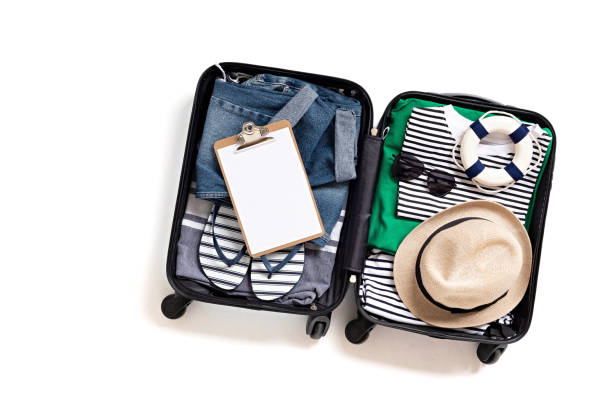 istock Flat lay with open suitcase with casual clothes for summer vacations over white background. Summer holidays, travel, tourism, flight luggage concept. 1213194610