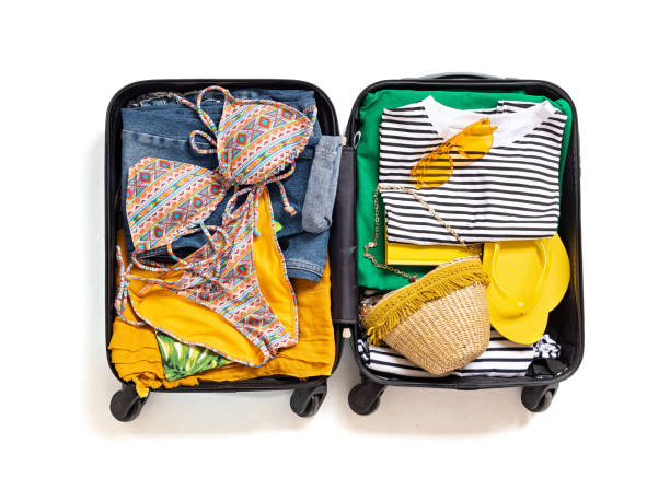 istock Flat lay with open suitcase with casual clothes for summer vacations over white background. Summer holidays, travel, tourism, flight luggage concept. 1213194621