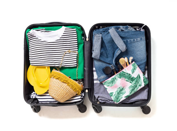 istock Flat lay with open suitcase with casual clothes for summer vacations over white background. Summer holidays, travel, tourism, flight luggage concept. 1213194626