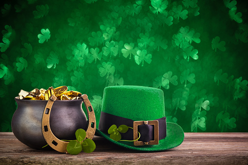 St Patrick's Day hat and pot with gold coins on green twinkling background