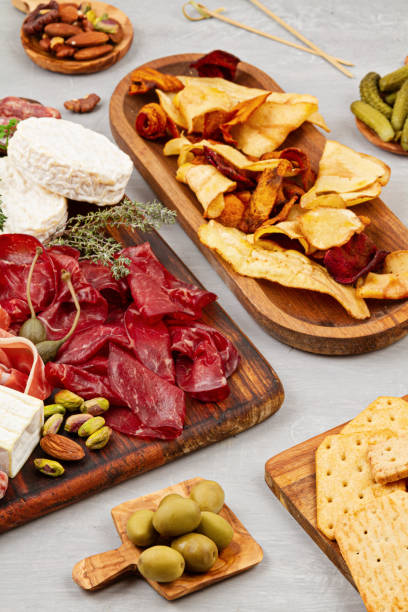 istock Appetizers table with differents antipasti, charcuterie, snacks and wine. Sausage, ham, tapas, olives, cheese and crackers for buffet party. 1213195068