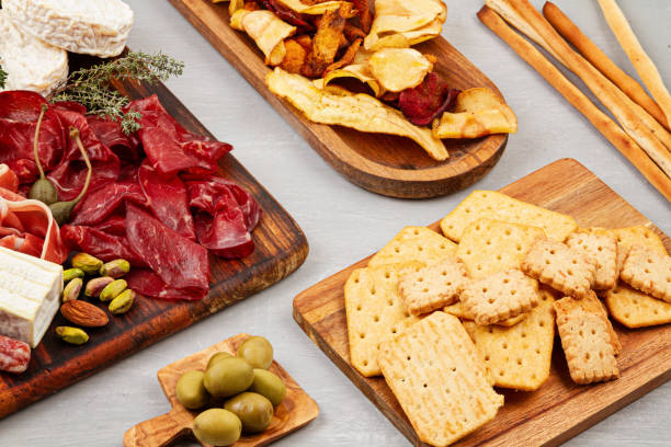 istock Appetizers table with differents antipasti, charcuterie, snacks and wine. Sausage, ham, tapas, olives, cheese and crackers for buffet party. 1213195079
