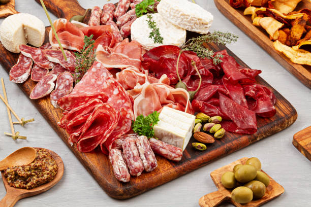 istock Appetizers table with differents antipasti, charcuterie, snacks and wine. Sausage, ham, tapas, olives, cheese and crackers for buffet party. 1213195080