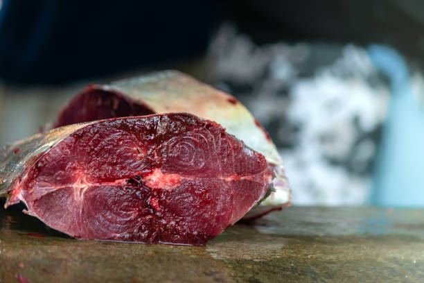 close up view of fresh cut tuna fillet on counter top at street market, copy space. - tuna steak tuna prepared ahi meat imagens e fotografias de stock