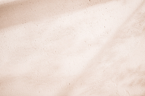 Clay eco-plaster texture. Sunny spring and summer rustic background.