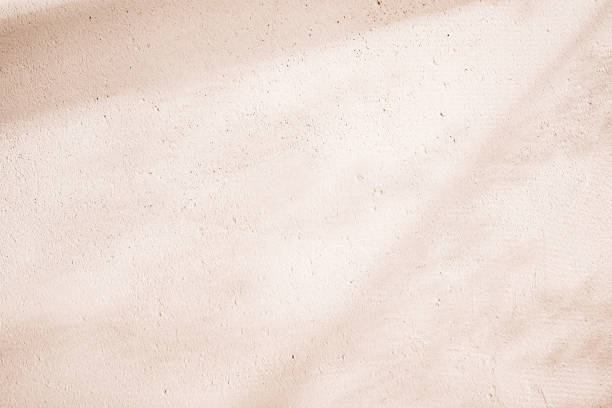 Clay eco-plaster texture. Sunny spring and summer rustic background Clay eco-plaster texture. Sunny spring and summer rustic background. adobe material stock pictures, royalty-free photos & images