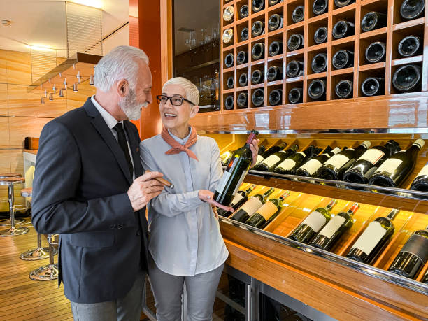 istock Senior couple choosing a wine for degustation in a winery cellar 1213199801