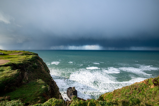 Band of rain over the sea in Cornwall as a storm rolls in