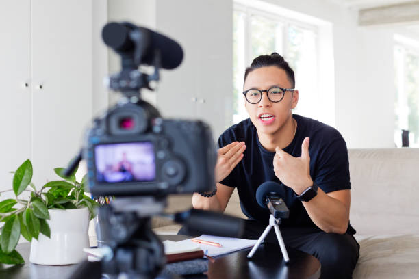 istock Young asian man vlogging in the office 1213200628