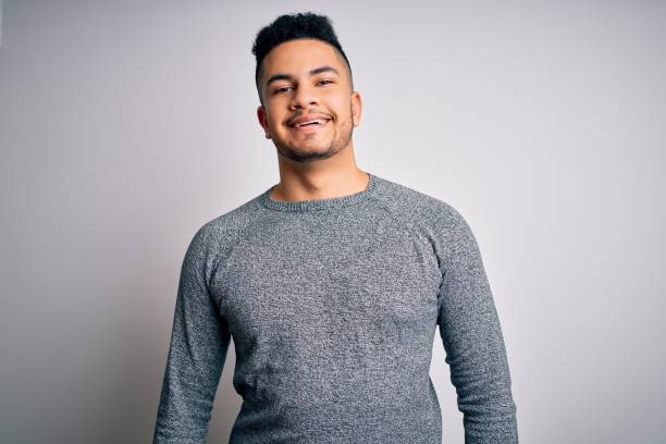 istock Young handsome man wearing casual sweater standing over isolated white background with a happy and cool smile on face. Lucky person. 1213200682