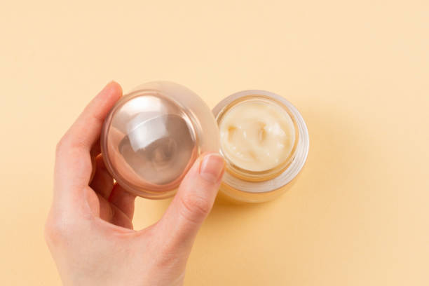 istock Hand cream and woman hands on a beige background. 1213201652