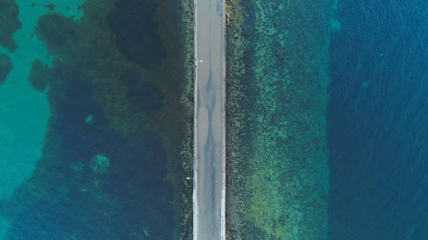 istock Aerial view of road between blue lake 1213202462