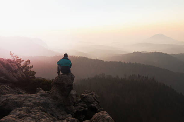 istock Lost man is sitting alone watching sunrise 1213202746