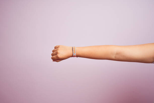 Arm of model woman with beautiful handmade colorful bracelet on wrist Model arm with beautiful handmade colorful bracelet on wrist friendship bracelets hands stock pictures, royalty-free photos & images