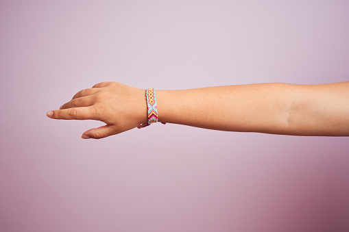 Model arm with beautiful handmade colorful bracelet on wrist