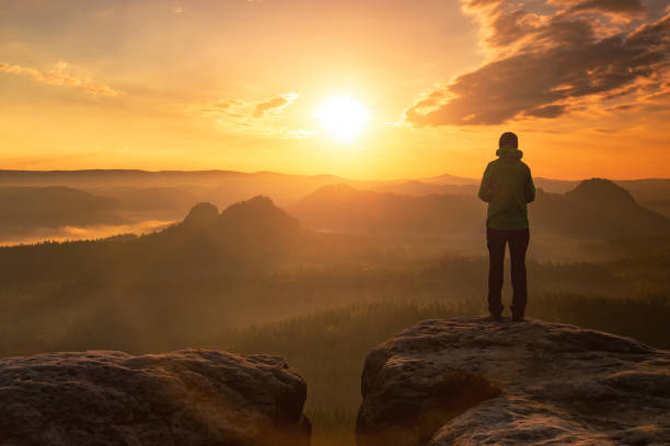 istock Hipster man with hat and green jacket watch 1213203117