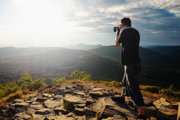 istock Man press camera on face and look into viewfinder 1213203310