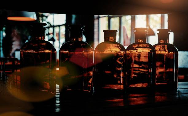Olive green glass bottle filled glass marble Spheres on antique paper backgroundThailand Asia