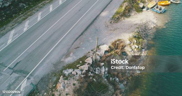 Aerial View Of Road Near Blue Lake Stock Photo - Download Image Now - Asphalt, Looking At View, Scenics - Nature