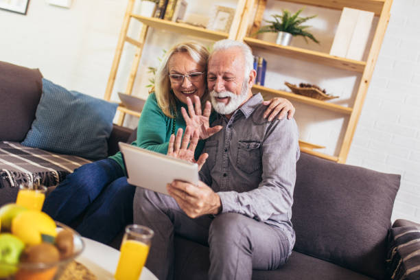 istock Senior couple making video call on digital tablet at home. 1213206715