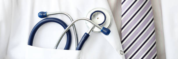 istock Male GP wearing tie holding stethoscope in smock pocket 1213208967