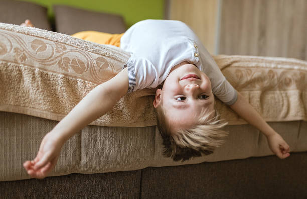 istock Little boy lying in bed upside down 1213211572