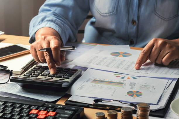 istock accounting concept. businesswoman working using calculator with money stack in office 1213212447