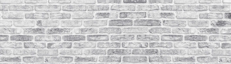 White washed shabby brick wall wide texture. Large light gray rustic brickwork wallpaper. Whitewashed panoramic vintage background
