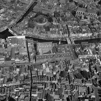 Leiden, Holland, May 07 - 1976: Historical black and white aerial photo of the center of Leiden with the Burcht, Town hall and Pieters church