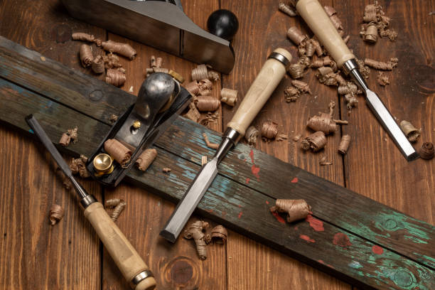 istock Chisel and small block plane with wood shavings 1213218193