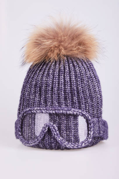 istock winter gray hat decorated with false ski glasses  and fur pom-pom 1213219381