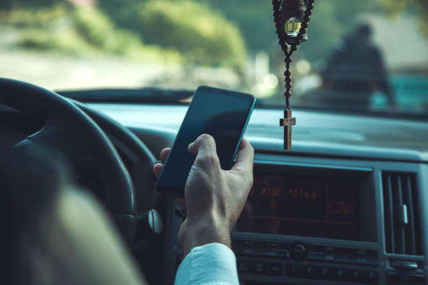 istock man hand smart phone in car 1213224757
