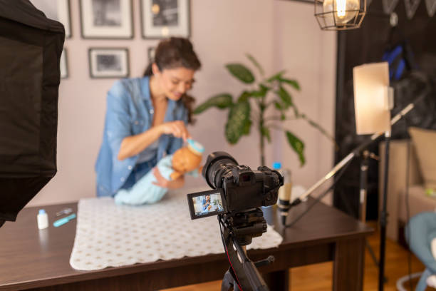 istock Vlogger making video about brushing newborn baby hair 1213226772