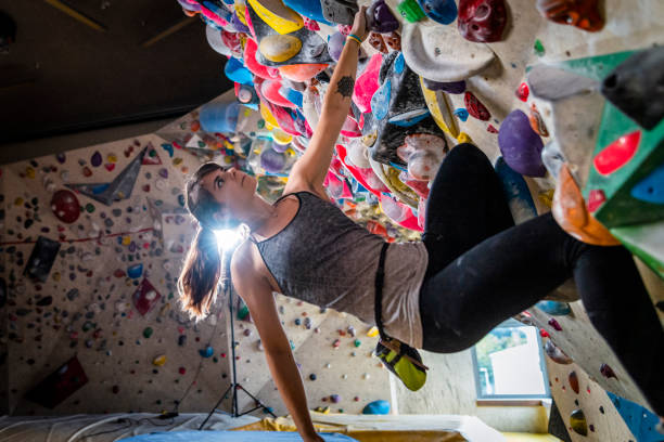 istock Woman climbing on climbing wall 1213227107