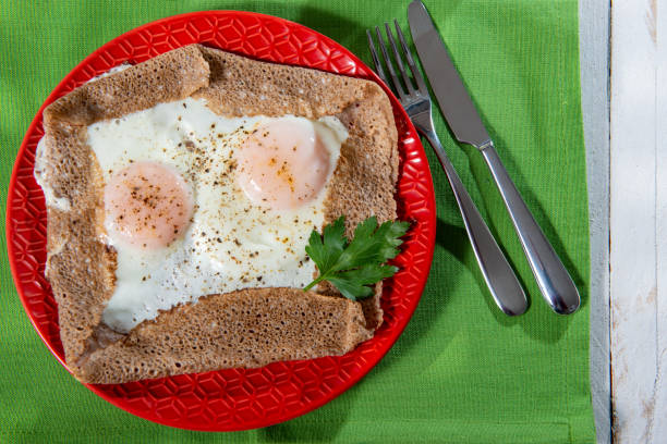 istock homemade Breton crepe with egg in a red plate 1213227306