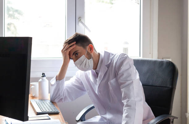 istock Man in quarantine for coronavirus working remote from home stills 1213228215