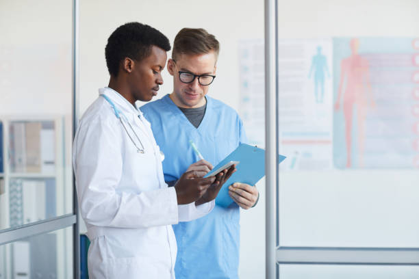 istock Doctors Filling Patient Reports in Clinic 1213228220