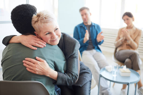 istock Mature Psychologist Embracing Patient in Support Group 1213228507