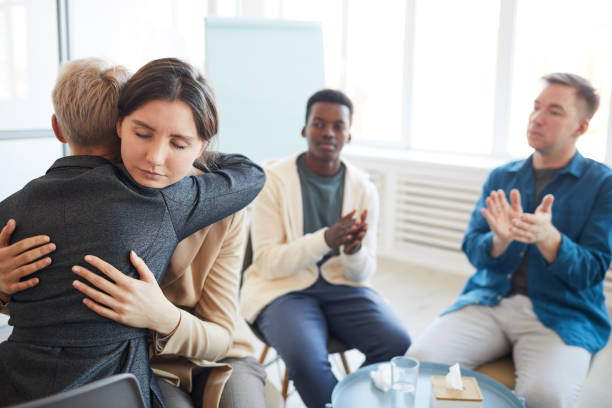 istock Psychologist Embracing Patient in Support Group 1213228517