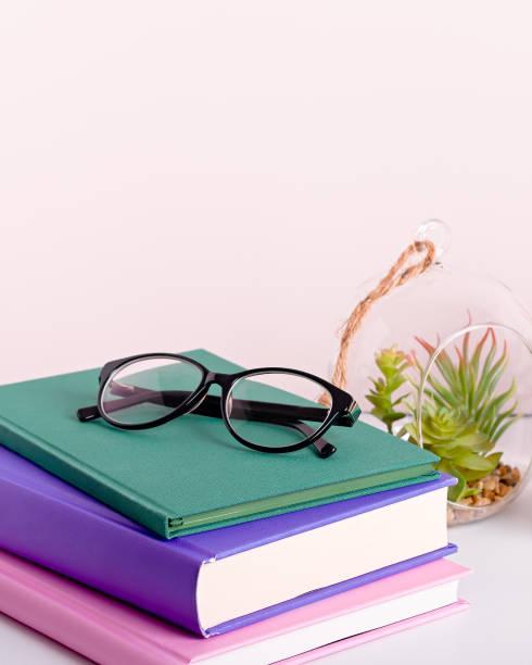 istock Multicolor books stack, house plants succulents and fragrant candle and sticks. Background for World Book Day. Still life with stack of colorful books and home interior decor 1213229617
