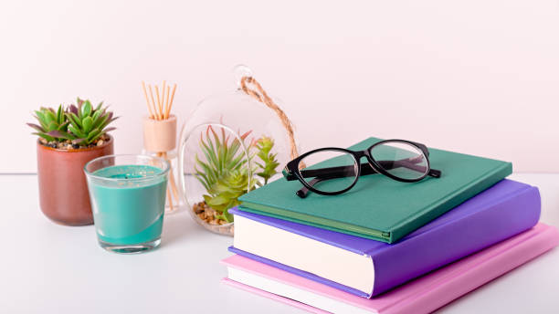 istock Books stack, eyeglasses, house plants succulents and fragrant candle and sticks. Background for World Book Day. Still life with stack of colorful books and home interior decor 1213229669