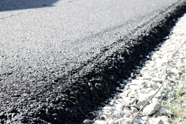 istock New layer of asphalt road under construction  with support from the European Union structural funds. 1213230007