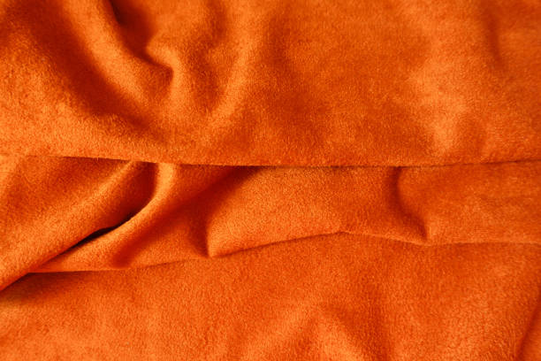 istock Bright reddish orange artificial suede fabric in soft folds 1213230718